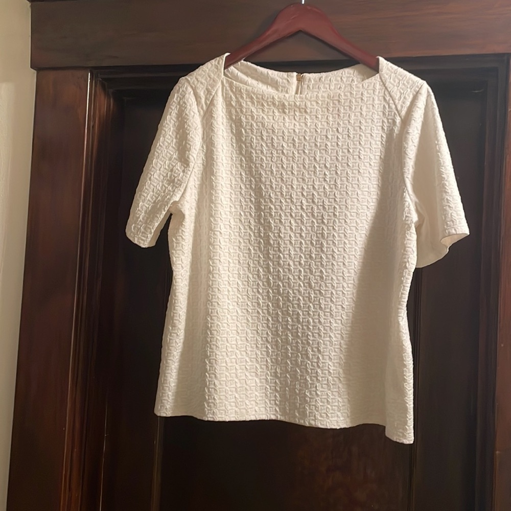 White, short sleeve Chico’s blouse. Never worn, no tags.